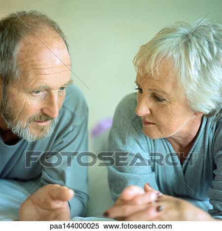Stock Photography - Mature couple lying side by side. Fotosearch