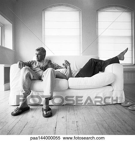 Mature couple on sofa, woman with head on man's lap, b&w View Large Photo Image Stock Photography - Mature couple on sofa, woman with head on man's lap, b&w. Fotosearch