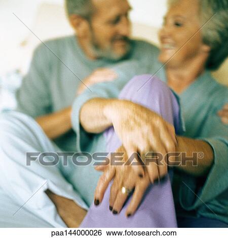 Mature couple sitting together, blurred View Large Photo Image Stock Photograph - Mature couple sitting together, blurred. Fotosearch