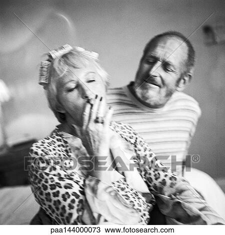 Mature couple sitting, woman smoking cigarette, b&w View Large Photo Image Stock Image - Mature couple sitting, woman smoking cigarette, b&w. Fotosearch