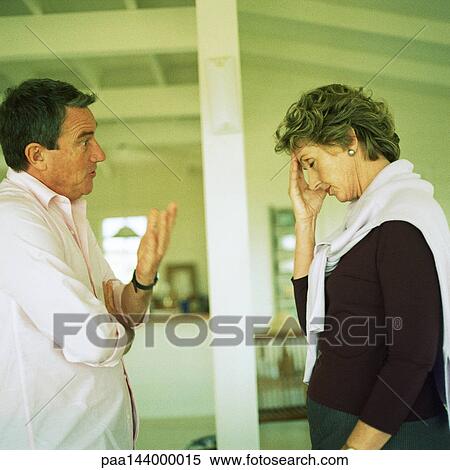 Mature couple standing face to face, man speaking View Large Photo Image Stock Photography - Mature couple standing face to face, man speaking. Fotosearch