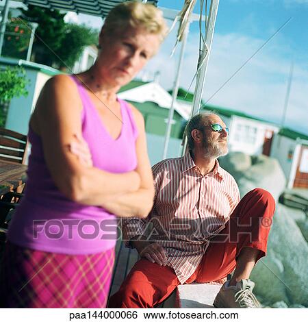 Mature man and woman outside, man wearing sunglasses View Large Photo Image Stock Photograph - Mature man and woman outside, man wearing sunglasses. Fotosearch