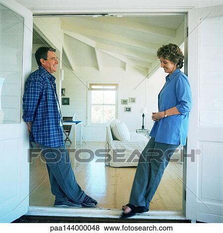 Mature man and woman standing face to face, smiling View Large Photo Image Stock Photo - Mature man and woman standing face to face, smiling. Fotosearch