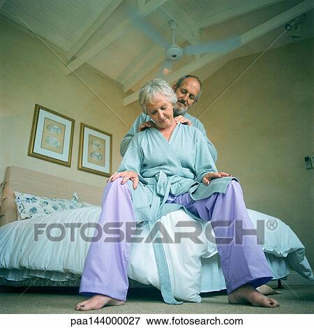 Mature man massaging woman, low angle view View Large Photo Image Stock Photo - Mature man massaging woman, low angle view. Fotosearch