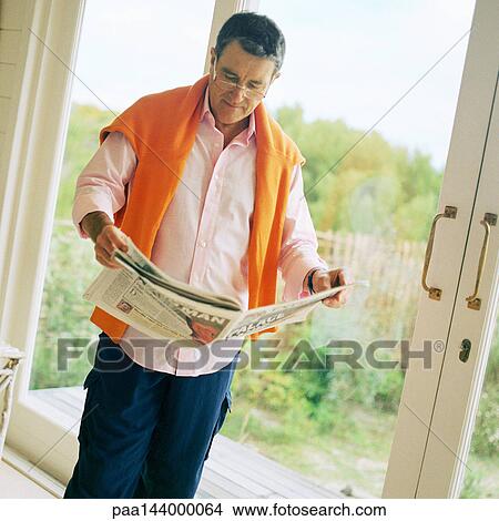 Mature man reading newspaper View Large Photo Image Picture - Mature man reading newspaper. Fotosearch