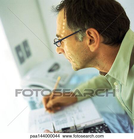 Mature man writing, side view View Large Photo Image Picture - Mature man writing, side view. Fotosearch