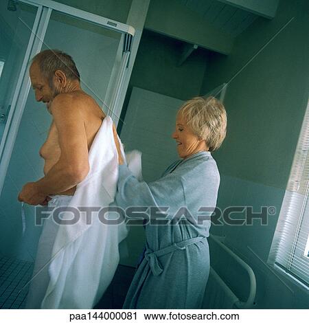 Mature woman drying man's bare back, side view View Large Photo Image Stock Image - Mature woman drying man's bare back, side view. Fotosearch