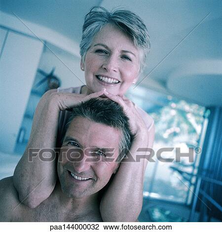 Mature woman, hands on man's head, smiling View Large Photo Image Stock Image - Mature woman, hands on man's head, smiling. Fotosearch