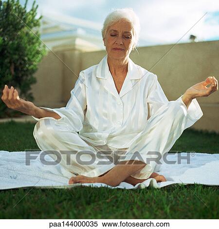Mature woman in lotus position, outside View Large Photo Image Stock Photography - Mature woman in lotus position, outside. Fotosearch