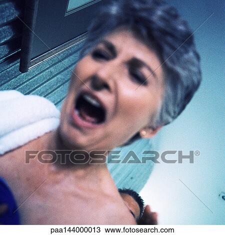 Mature woman open-mouthed, low angle view, blurred View Large Photo Image Stock Image - Mature woman open-mouthed, low angle view, blurred. Fotosearch