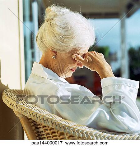 Mature woman sitting, hand on face, side view View Large Photo Image Stock Photo - Mature woman sitting, hand on face, side view. Fotosearch