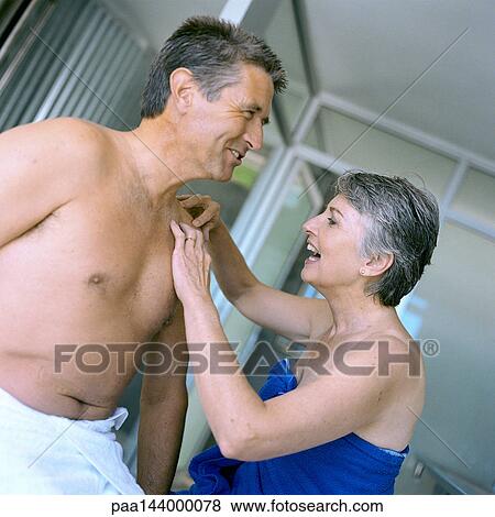 Mature woman touching man's bare shoulder View Large Photo Image Stock Photo - Mature woman touching man's bare shoulder. Fotosearch