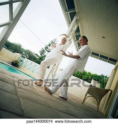 Senior couple dancing near swimming pool View Large Photo Image Picture - Senior couple dancing near swimming pool. Fotosearch