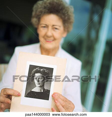 Senior woman showing photo View Large Photo Image Stock Image - Senior woman showing photo. Fotosearch