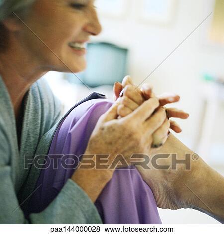 Woman massaging someone's foot, close-up View Large Photo Image Stock Photo - Woman massaging someone's foot, close-up. Fotosearch