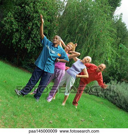 Four mature people standing in line outdoors View Large Photo Image Stock Photo - Four mature people standing in line outdoors. Fotosearch