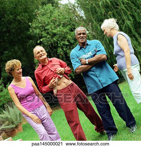 Four mature people standing outdoors View Large Photo Image Stock Image - Four mature people standing outdoors. Fotosearch