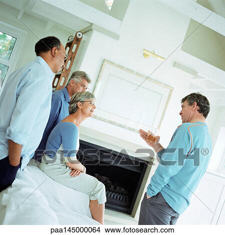 Four mature people talking in a room View Large Photo Image Picture - Four mature people talking in a room. Fotosearch