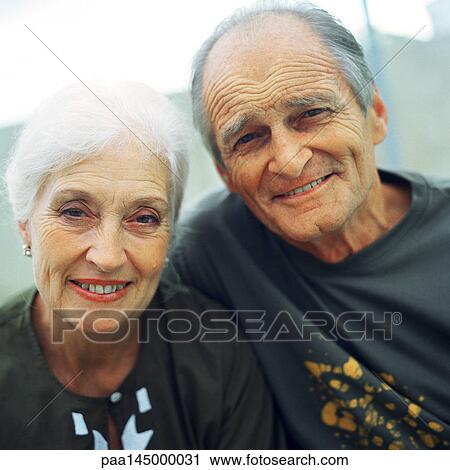 Mature couple close together, smiling at camera View Large Photo Image Stock Image - Mature couple close together, smiling at camera. Fotosearch