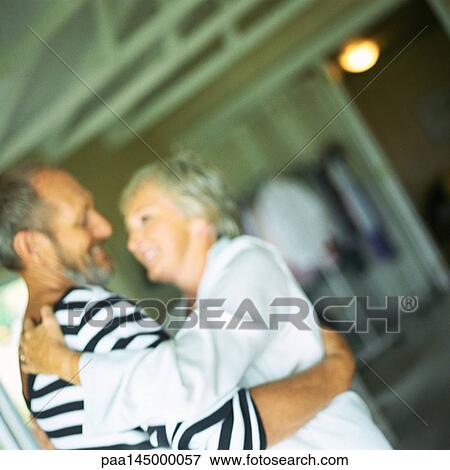 Mature couple hugging, blurred View Large Photo Image Stock Photo - Mature couple hugging, blurred. Fotosearch