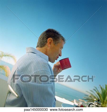 Mature man drinking from mug, side view View Large Photo Image Stock Image - Mature man drinking from mug, side view. Fotosearch