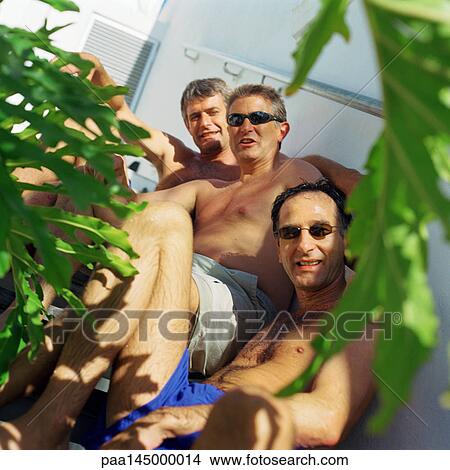 Three bare-chested men looking into camera View Large Photo Image Picture - Three bare-chested men looking into camera. Fotosearch
