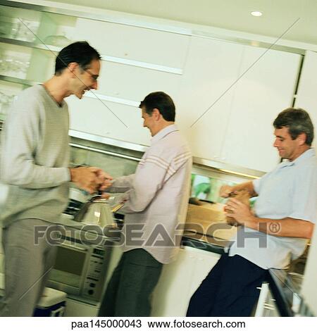 Three men standing in kitchen View Large Photo Image Stock Image - Three men standing in kitchen. Fotosearch