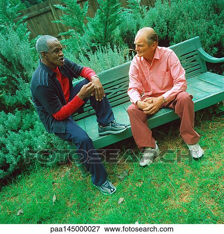 Two mature men sitting on bench View Large Photo Image Stock Photo - Two mature men sitting on bench. Fotosearch