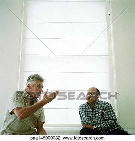 Two mature men sitting, one speaking View Large Photo Image Stock Image - Two mature men sitting, one speaking. Fotosearch