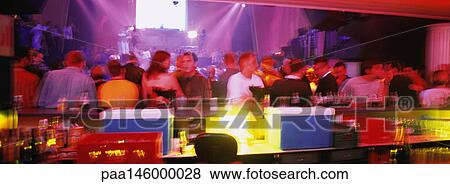 Bar counter, with crowd of people and concert in background, blurred View Large Photo Image Stock Photo - Bar counter, with crowd of people and concert in background, blurred. Fotosearch