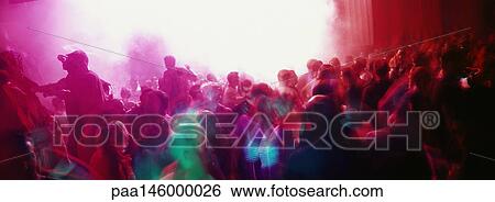 Stock Photograph - Crowd of people dancing at a nightclub. Fotosearch