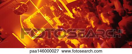 Stock Photo - Crowd of people dancing at nightclub, blurred. Fotosearch