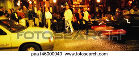 Crowd of people standing next to street, at night, blurred View Large Photo Image Stock Image - Crowd of people standing next to street, at night, blurred. Fotosearch
