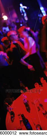 Stock Image - People dancing in nightclub, blurred. Fotosearch