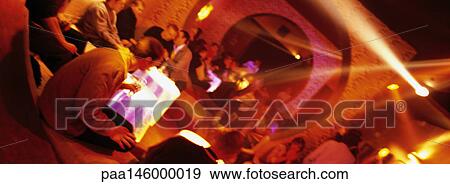 People sitting at tables in nightclub View Large Photo Image Stock Photo - People sitting at tables in nightclub. Fotosearch