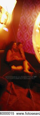 People sitting on sofa in nightclub, blurred View Large Photo Image Stock Photography - People sitting on sofa in nightclub, blurred. Fotosearch