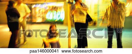 People waiting at bus stop at night, blurred View Large Photo Image Stock Image - People waiting at bus stop at night, blurred. Fotosearch