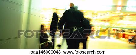 Police officer coming from hall going into shopping center, blurred View Large Photo Image Stock Photo - Police officer coming from hall going into shopping center, blurred. Fotosearch