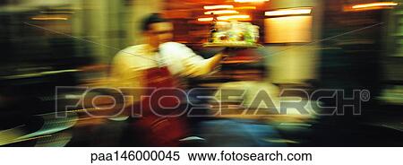 Waiter in restaurant, blurred View Large Photo Image Stock Photography - Waiter in restaurant, blurred. Fotosearch