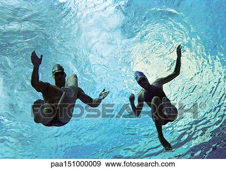 Couple swimming underwater, underwater view. View Large Photo Image Stock Photo - Couple swimming underwater, underwater view.. Fotosearch