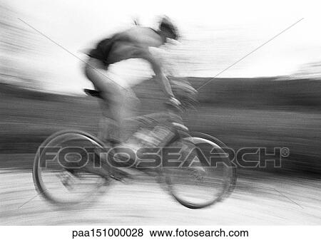 Man cycling, side view, blurred, b&w. View Large Photo Image Stock Photo - Man cycling, side view, blurred, b&w. . Fotosearch