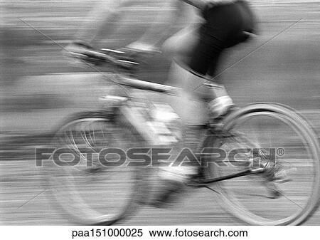 Stock Photography - Man cycling, side view, blurred, b&w. . Fotosearch