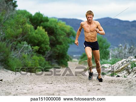 Man in shorts running along Mountain trail. View Large Photo Image Stock Photo - Man in shorts running along Mountain trail.. Fotosearch