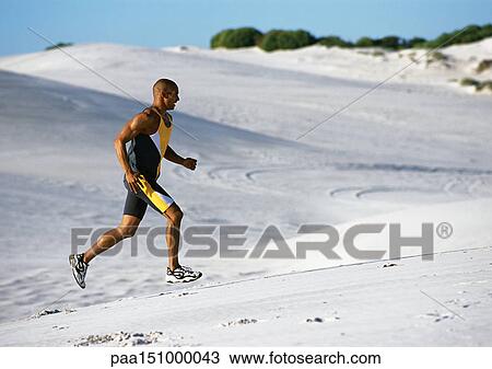 Man jogging on beach. View Large Photo Image Stock Image - Man jogging on beach.. Fotosearch