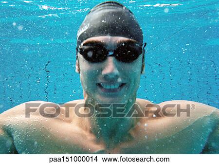 Picture - Man smiling underwater, underwater view.. Fotosearch