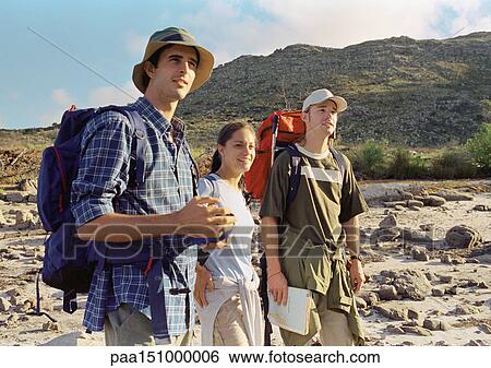 Stock Photograph - Three young people hiking. Fotosearch