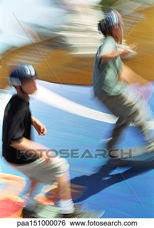 Two young men on skateboards, blurred. View Large Photo Image Stock Photograph - Two young men on skateboards, blurred.. Fotosearch