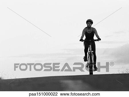 Woman cycling, b&w. View Large Photo Image Stock Image - Woman cycling, b&w.. Fotosearch