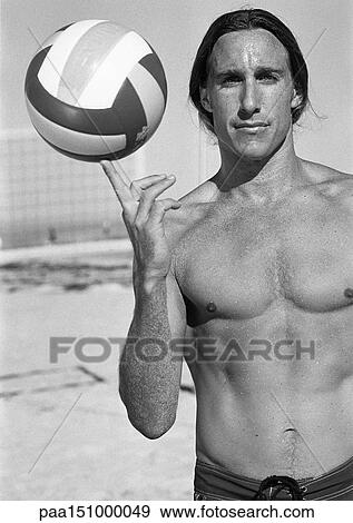 Young bare-chested man, holding volleyball on finger, portait, b&w. View Large Photo Image Stock Photo - Young bare-chested man, holding volleyball on finger, portait, b&w.. Fotosearch