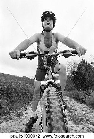 Young man on mountain bike, low angle view. View Large Photo Image Stock Image - Young man on mountain bike, low angle view.. Fotosearch